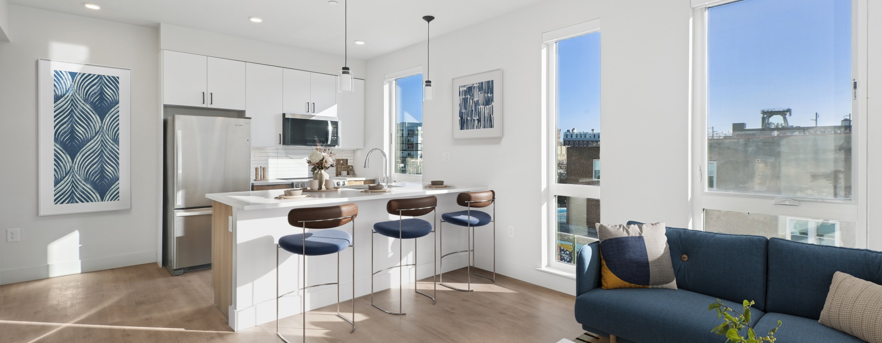 kitchen with white cabinets and blue couch
